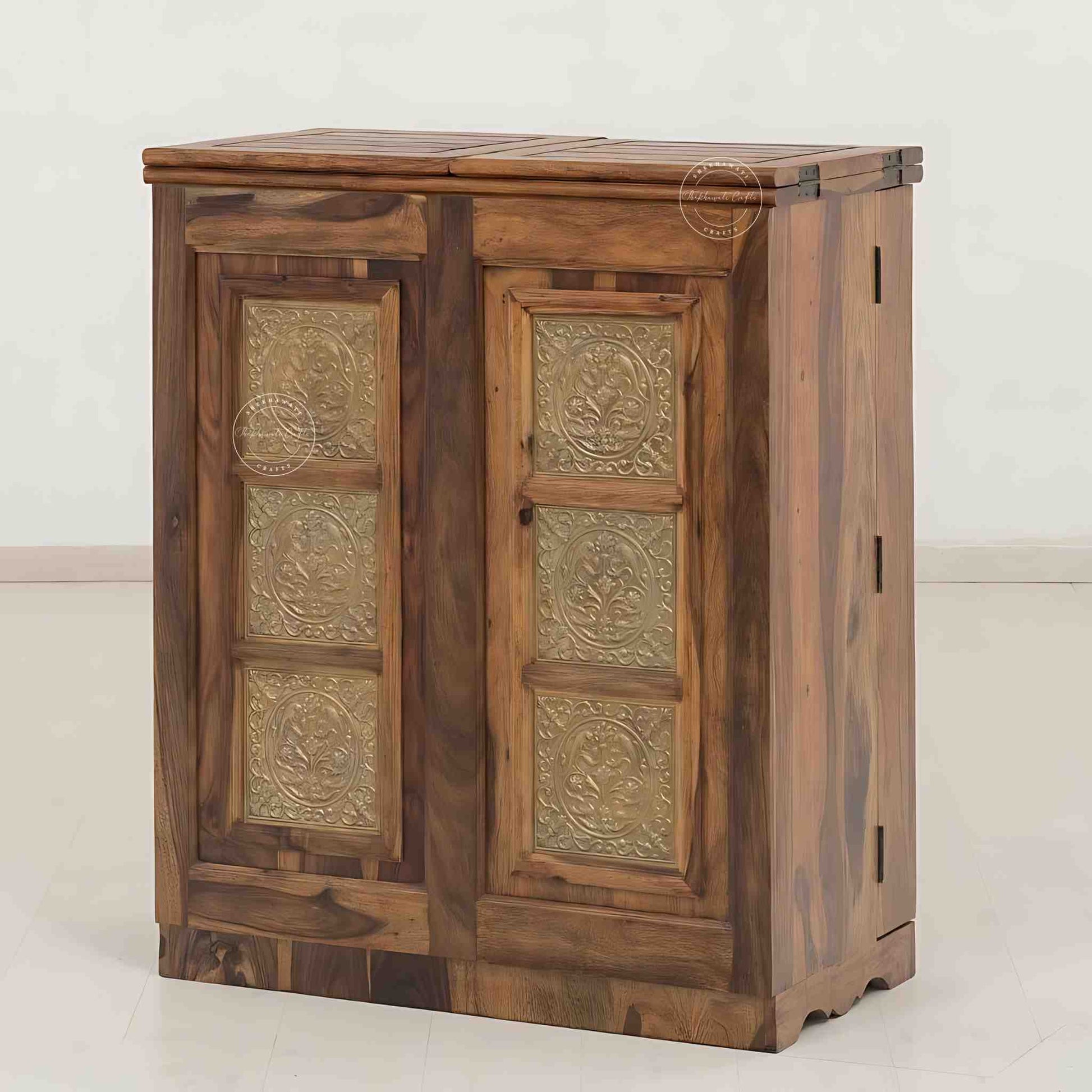 Handmade Sheesham wood bar cabinet with antique brass detailing, natural finish, two doors, spacious drawers, and dedicated storage for bottles and glasses. Ideal for home bar furniture.